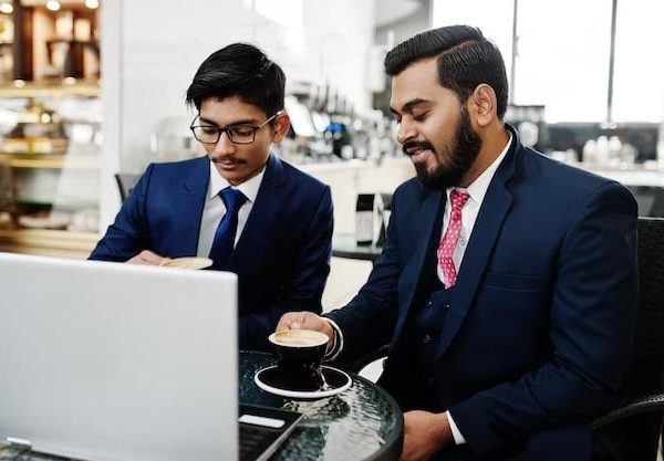 two-indian-business-man-suits-sitting-office